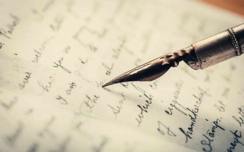 writer or an author writing in a paper and holding a pen